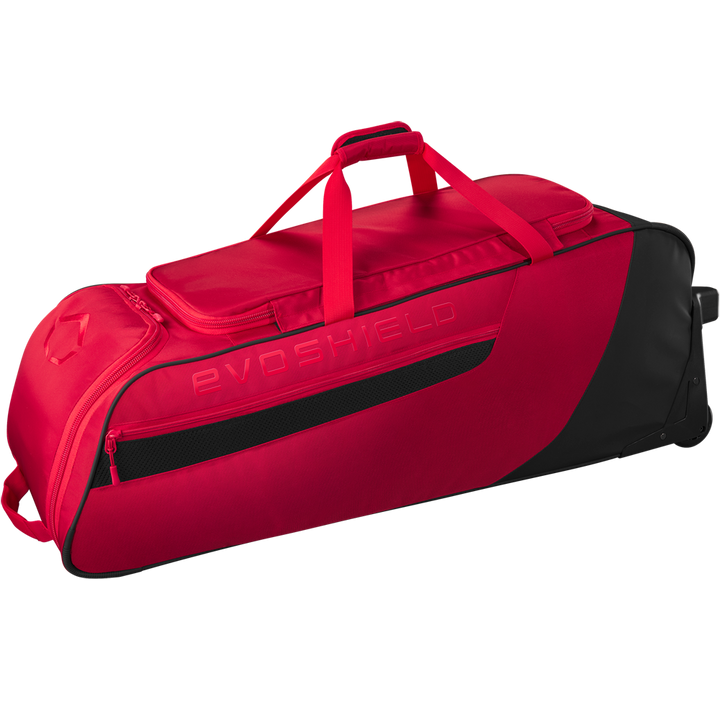The EvoShield Takeover Wheeled Bag (WB57572) is a spacious red and black baseball gear bag with wheels, handle, shoulder strap, zippered pocket, bat sleeves, and EVOSHIELD branding on the side.