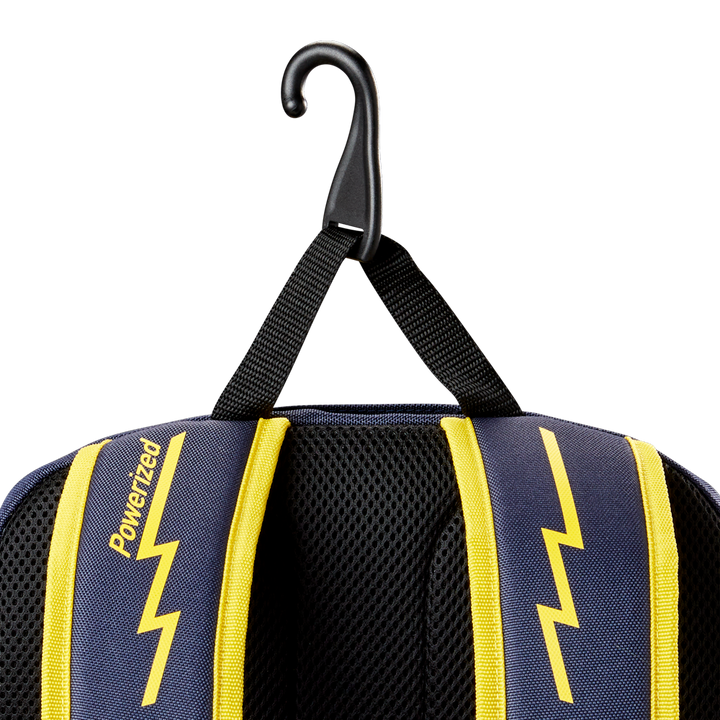 Close-up of the Louisville Slugger Savannah Bananas Powerized Stick Pack Backpack (WB57636), with blue and yellow lightning bolt straps, "Powerized" printed on a strap, hanging from a black hook by its loop.