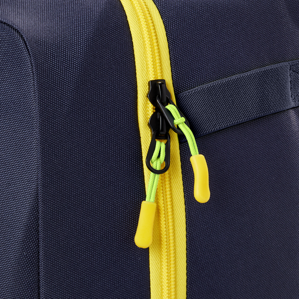 Close-up of the Louisville Slugger Savannah Bananas Powerized Stick Pack Backpack (WB57636), a navy blue youth baseball bag featuring a yellow zipper, green zipper pulls with yellow tabs, and a partially visible fabric handle on the right.