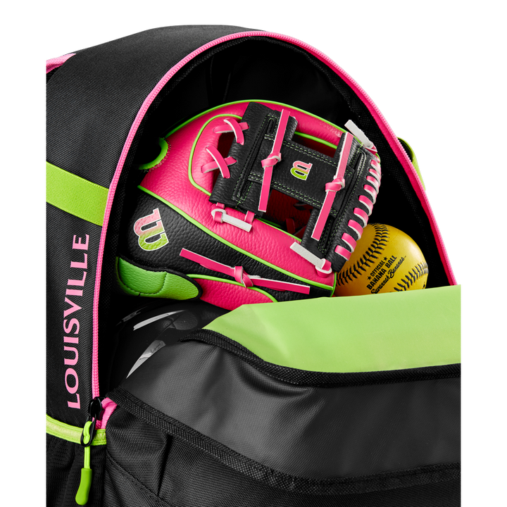 A close-up of an open Louisville Slugger Party Animals Powerized Stick Pack Backpack reveals a neon pink and black Wilson softball glove and two yellow softballs inside its main compartment.