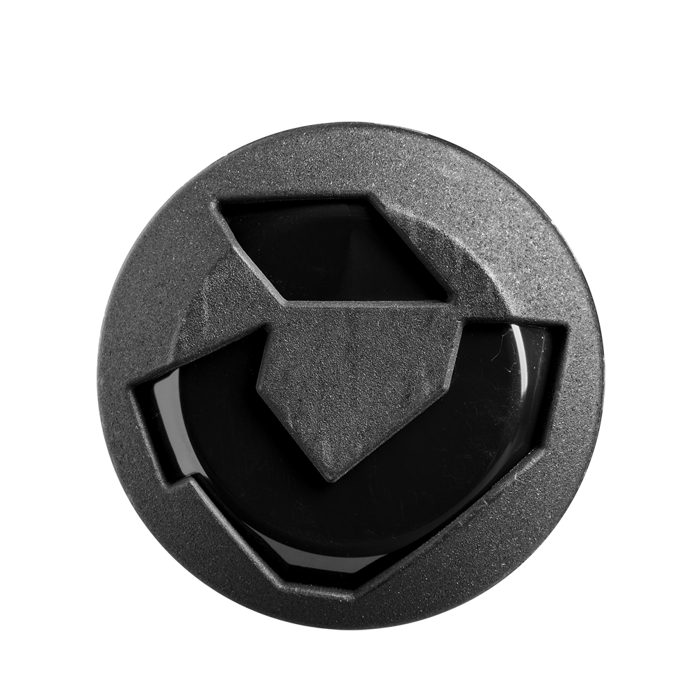 A round, black object with an angular geometric design and raised shapes, resembling the 2025 DeMarini Steel All Association Slowpitch Softball Bat: WBD2519010 barrel by DeMarini, is viewed from above against a white background.