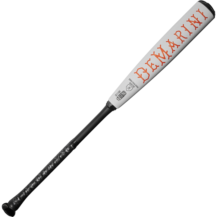 The 2025 DeMarini The Goods (-5) 2 5/8" USSSA Baseball Bat (WBD2537010) features a white and black design, X14 Alloy Barrel, textured black handle, and "DeMarini" in bold red letters along the barrel.