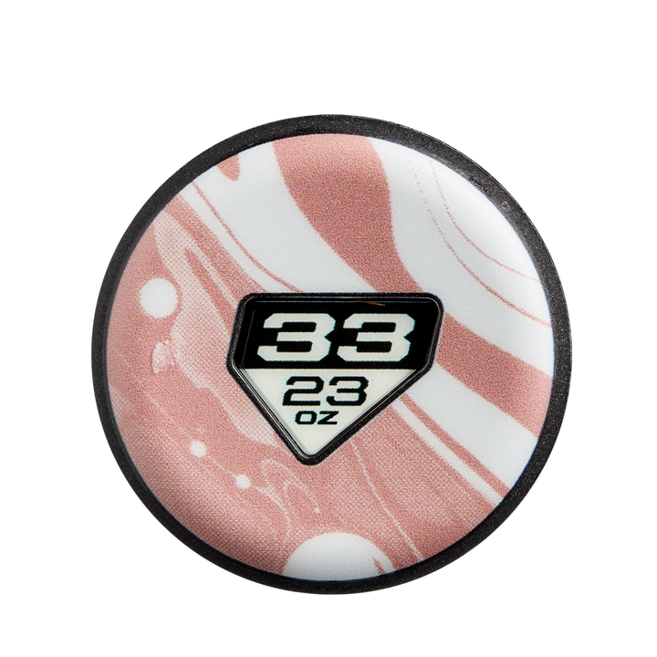A round white and pink swirled object resembling a 2025 DeMarini Whisper (-10) Fastpitch Softball Bat: WBD2544010 features a black-edged diamond label, with "33" above "23 oz" in bold black at the center, echoing DeMarini's signature design.