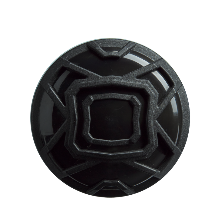 A black, circular object with a geometric raised angular pattern—resembling the end cap of the DeMarini The Goods (-3) BBCOR Baseball Bat (2026, WBD2588010)—is viewed from above against a plain white background.