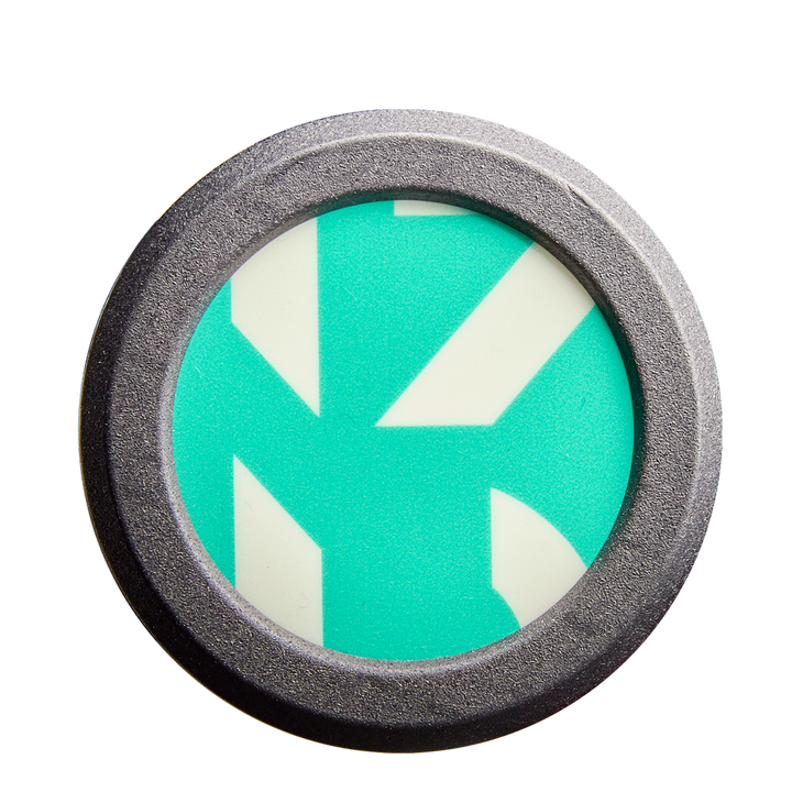 A round metal object frames a teal and white geometric design with bold, angular lines—resembling the eye-catching patterns found on the DeMarini CF FE (-11) Fastpitch Softball Bat: WBD2630010 (DEMO).