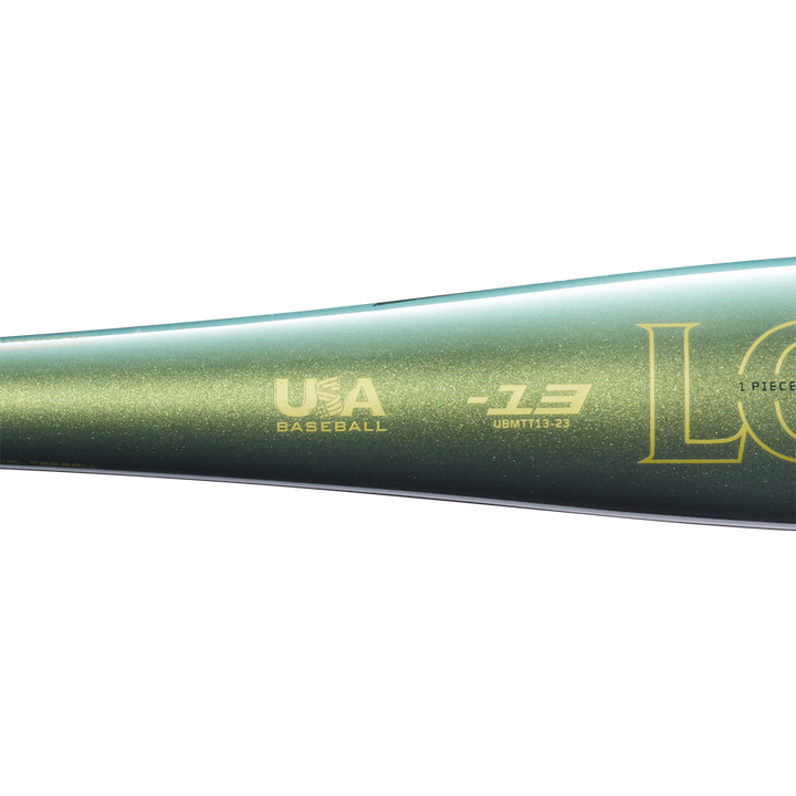 Close-up of the metallic green 2023 Louisville Slugger Meta (-13) 2 5/8" USA T-Ball Baseball Bat (WBL2667010) with gold USA Baseball and Louisville Slugger logos on its barrel, shown against a plain white background.
