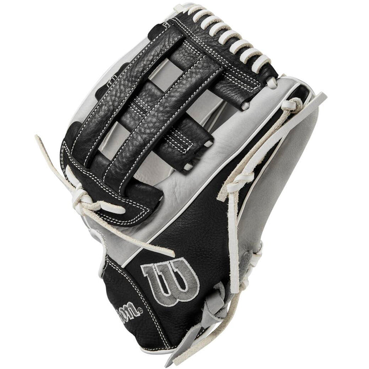 The Wilson A1000 IF12 12" Fastpitch Glove (WBW10145612) is a black and white glove with white stitching and laces, a woven web design, and the Wilson logo displayed on the thumb.