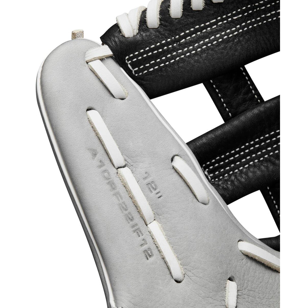 Close-up of the Wilson A1000 IF12 12" Fastpitch Glove (WBW10145612) in black and white, highlighting detailed stitching, lacing, and embossed model and size info on the white leather.
