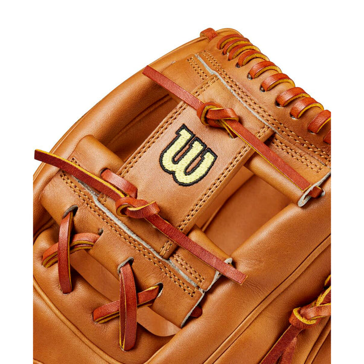 Close-up of a tan Wilson A2000 1975 11.75" Glove Day Series baseball glove (WBW1020761175) with red laces and a black-and-yellow "W" logo stitched on the back.