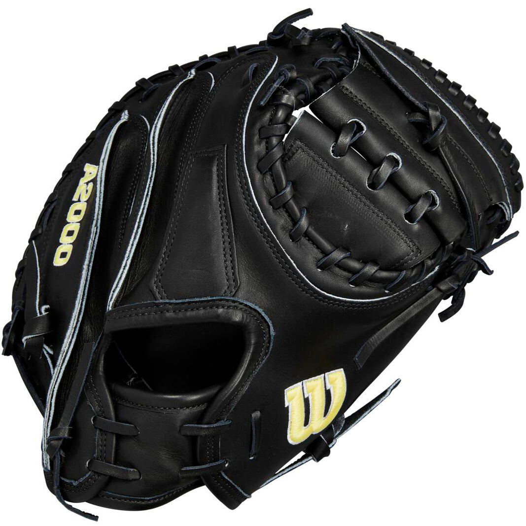 The Wilson A2000 M23 33.5" black catcher's mitt features white stitching, Pro Stock leather, "A2000" embroidered in yellow on the thumb, and a yellow W logo on the lower palm.