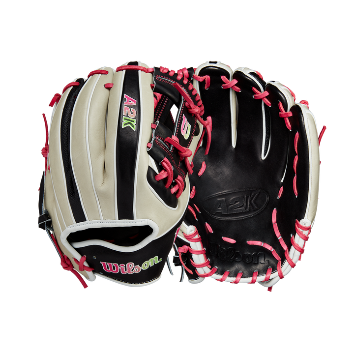 Two Wilson A2K 1724 11.75" GOTM June 2024 baseball gloves by Wilson, made with Pro Stock Select leather in black, beige, and pink, feature white/pink laces and green/pink embroidered logos. Front and back views shown.