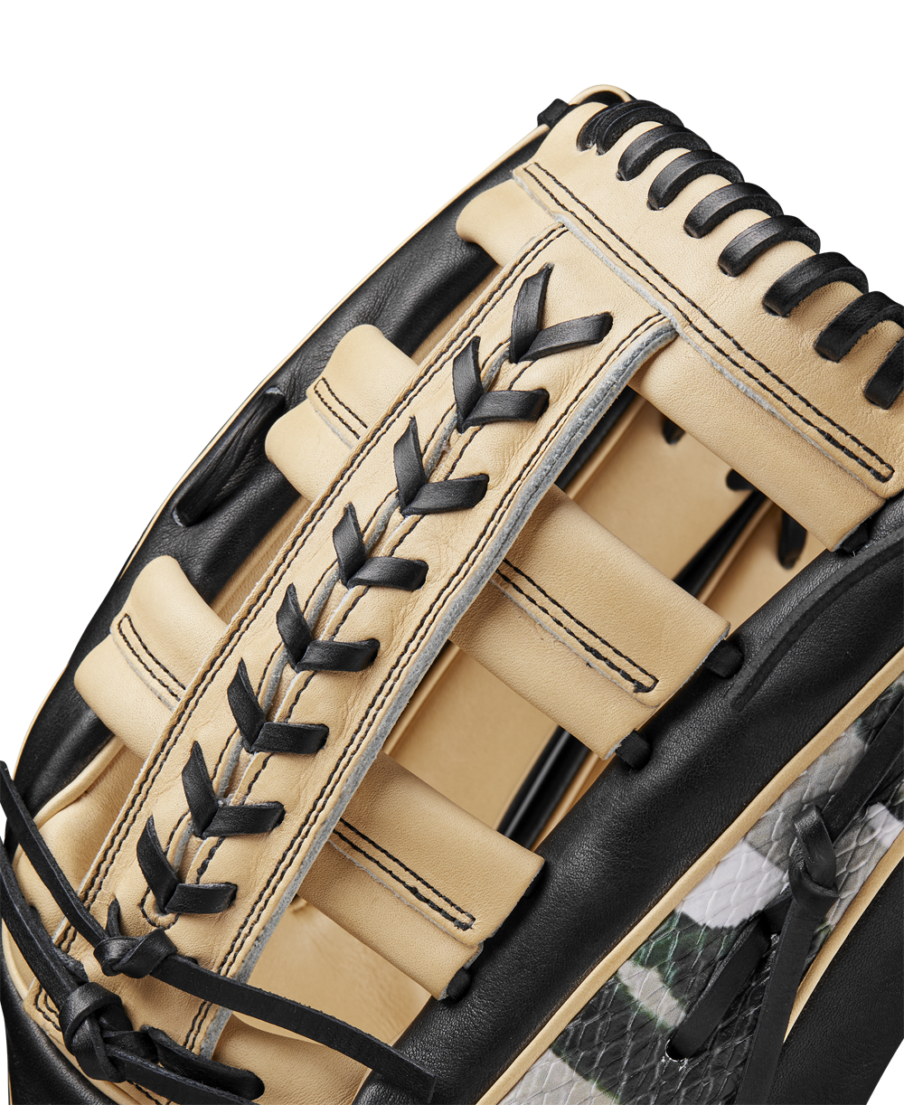 Close-up of a Wilson A2000 1810 12.75" Baseball Glove (Winter 2024), made of tan and black Pro Stock leather with black lacing, highlighting its detailed texture, stitching, and craftsmanship.