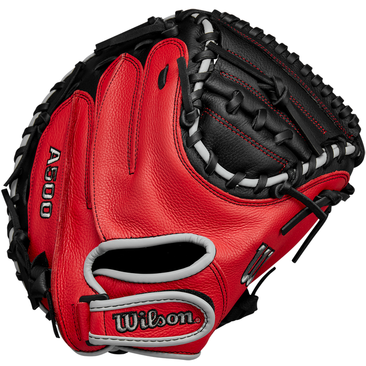 A Wilson A500 32" Baseball Catcher's Mitt (WBW10254632) in red and black with white lacing is shown from the front, displaying the Wilson brand name and webbing details.