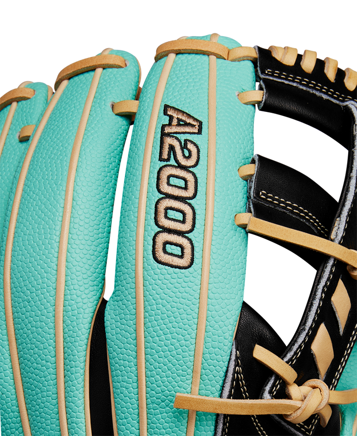 Close-up of the Wilson A2000 1716SS 11.5" Baseball Glove (WBW102547115), featuring turquoise and tan Pro Stock leather, black and gold A2000 embroidery, black laces, and visible stitching. Brand: Wilson. Spring 2025 release.