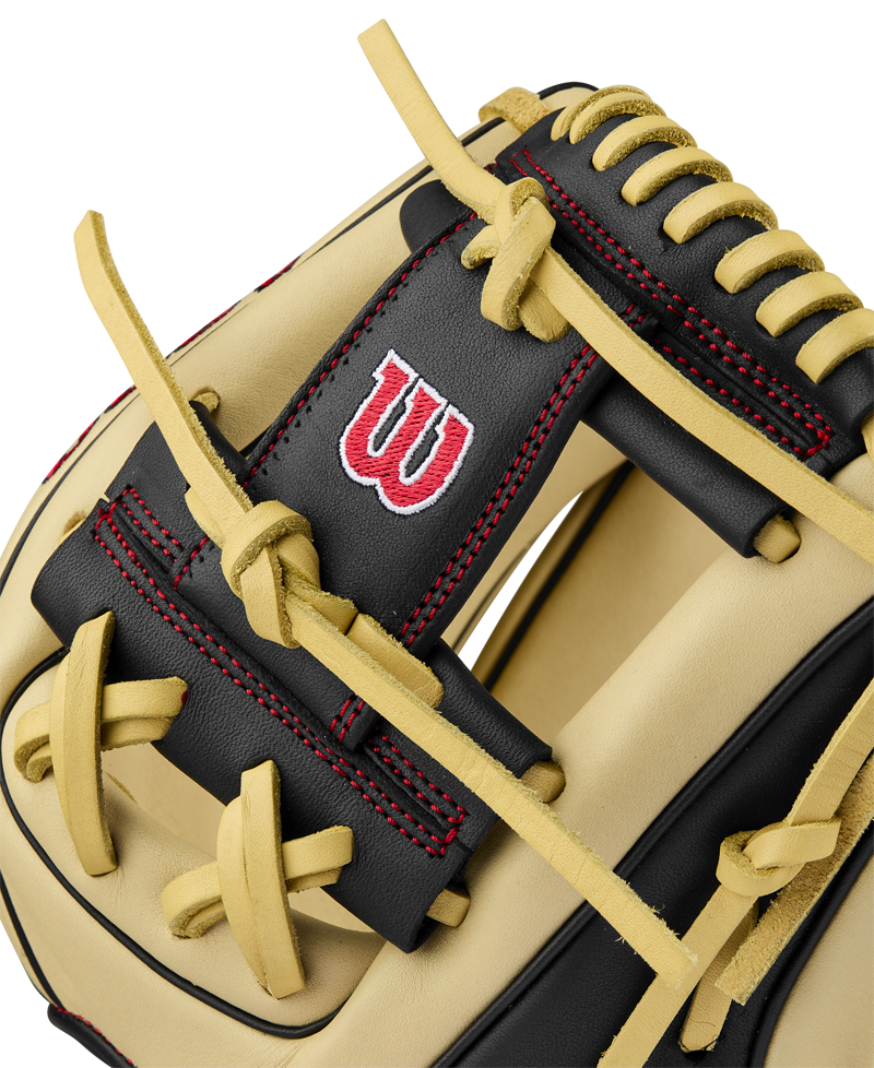 Close-up of the Wilson A900 PF115 11.5" Baseball Glove (WBW102570115), featuring tan and black leather, yellow laces, red stitching, and a red and white W logo—crafted in Pedroia Fit for comfortable youth infield play.