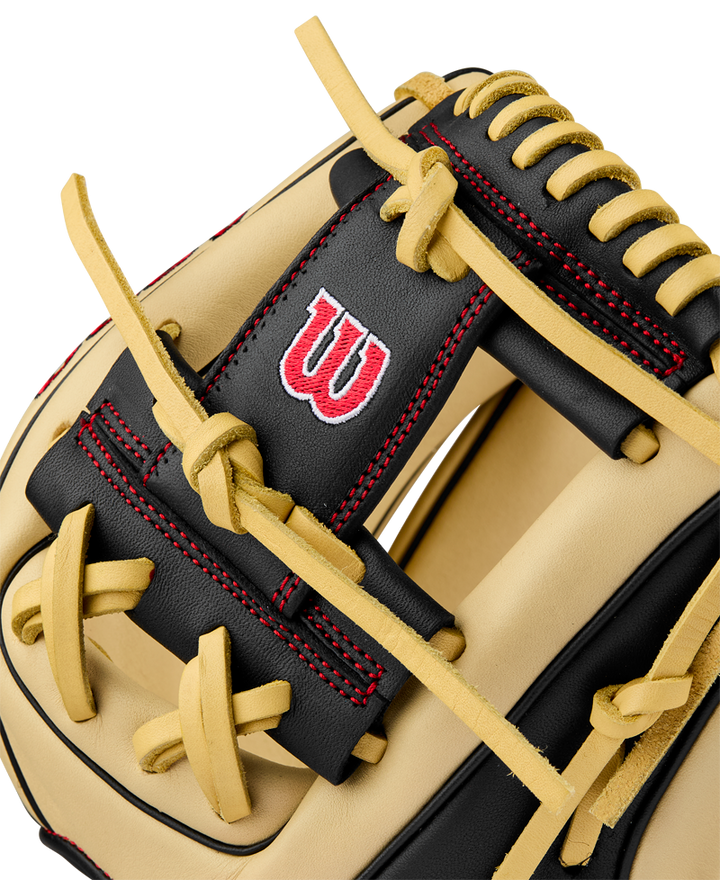 Close-up of the Wilson A900 PF115 11.5" Baseball Glove (WBW102570115), featuring tan and black leather, yellow laces, red stitching, and a red and white W logo—crafted in Pedroia Fit for comfortable youth infield play.
