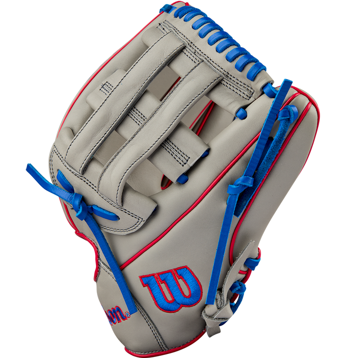 The Wilson A900 PF12 12" Baseball Glove: WBW10257112 features a grey design with blue lacing, red accents, and the Wilson W logo on the thumb. Its Pedroia Fit makes it ideal for youth baseball players seeking comfort and performance.