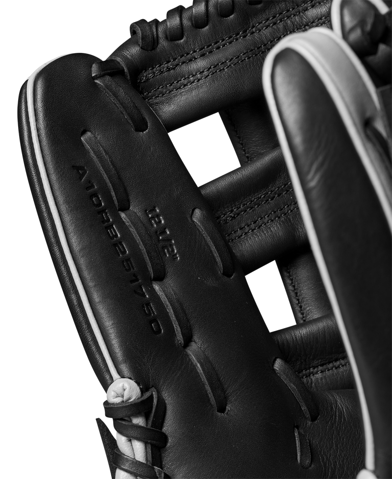 Close-up of the Wilson A1000 1750 12.5" Baseball Glove (WBW102585125), featuring black full grain leather, detailed stitching, and visible embossed text that highlights the glove’s quality craftsmanship.