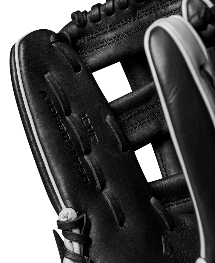 Close-up of the Wilson A1000 1750 12.5" Baseball Glove (WBW102585125), featuring black full grain leather, detailed stitching, and visible embossed text that highlights the glove’s quality craftsmanship.
