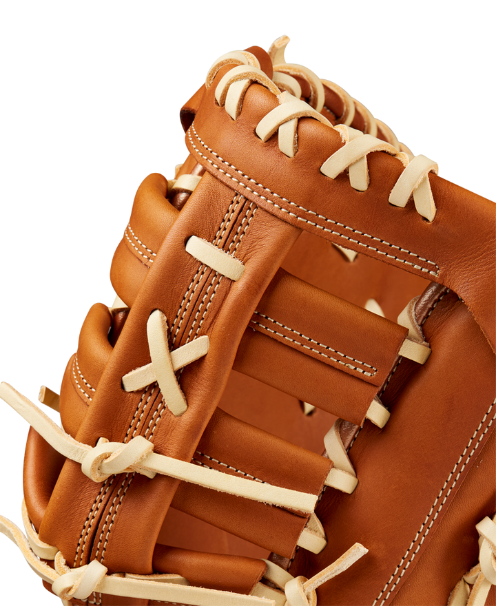 Close-up of the Wilson A1000 1620 12.5" First Base Mitt (WBW102587125) in brown, highlighting detailed white laces and stitching with smooth full grain leather, set against a plain background.
