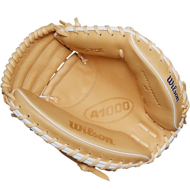 The Wilson A1000 CM33 33" Baseball Catcher's Mitt (WBW10258933) by Wilson, shown in tan with white laces, highlights its open interior, brand details, and premium Full Grain leather construction.