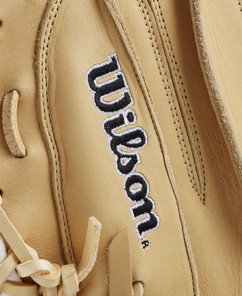 Close-up of a tan Wilson A1000 CM33 33" Baseball Catcher's Mitt (WBW10258933), showcasing full grain leather, detailed stitching, and the embroidered black and white “Wilson” logo.
