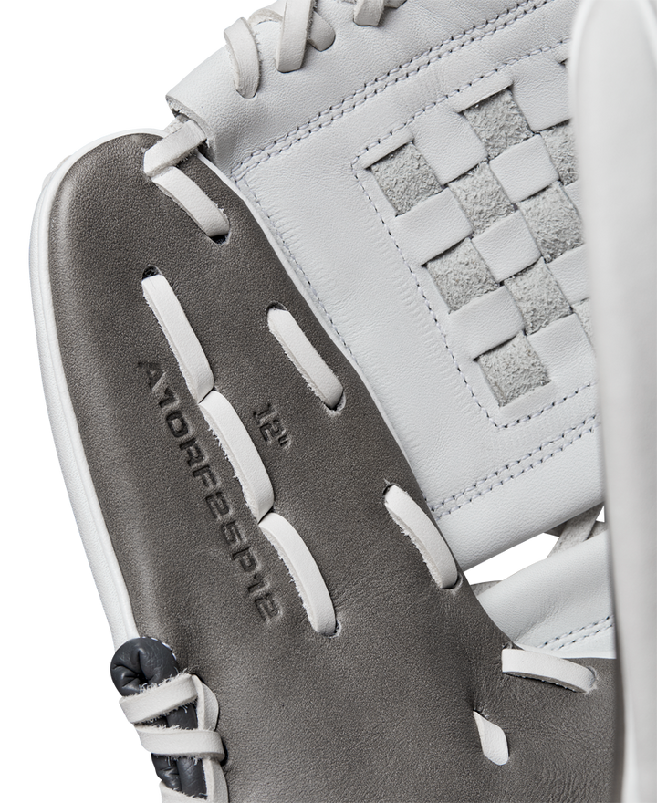 Close-up of a Wilson A1000 P12 12" Fastpitch Glove (WBW10259212) shows gray and white Full Grain leather, visible stitching, and a woven rectangular pattern with "A1000 P12 12”" embossed inside the glove.