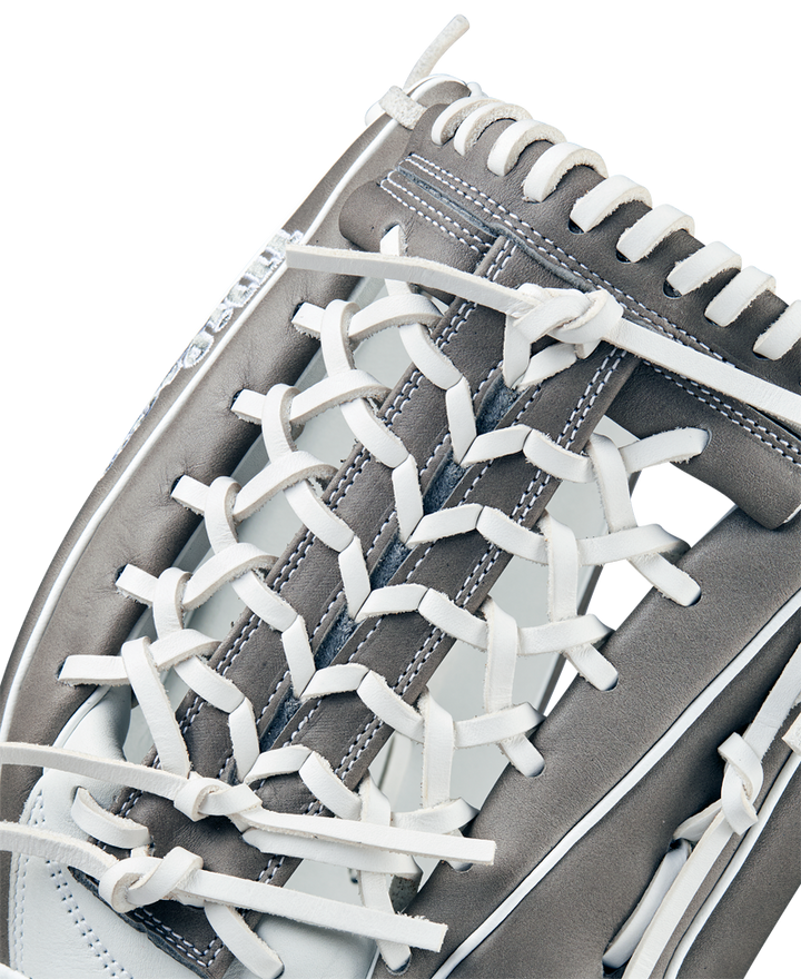 Close-up of the Wilson A1000 T125 12.5" Fastpitch Glove (WBW102596125) by Wilson, featuring detailed white lacing, grey full grain leather, and intricate stitching that highlights its textured outfield design.