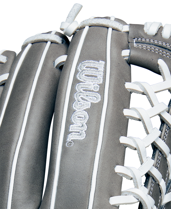 Close-up of the Wilson A1000 T125 12.5" Fastpitch Glove (WBW102596125) in gray, featuring white stitching and laces, full grain leather, and the embroidered Wilson logo on the leather surface.