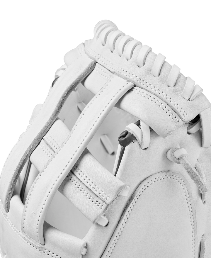 Close-up view of the Wilson A1000 CM33 33" Fastpitch Catcher's Mitt, crafted from full grain leather with detailed stitching, laces, and padding on the webbing and thumb area.