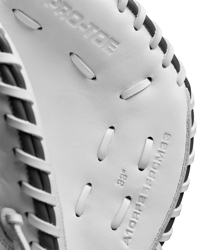 Close-up of the Wilson A1000 CM33 33" Fastpitch Catcher's Mitt by Wilson, made from full grain leather with detailed stitching, black laces, and embossed interior text.