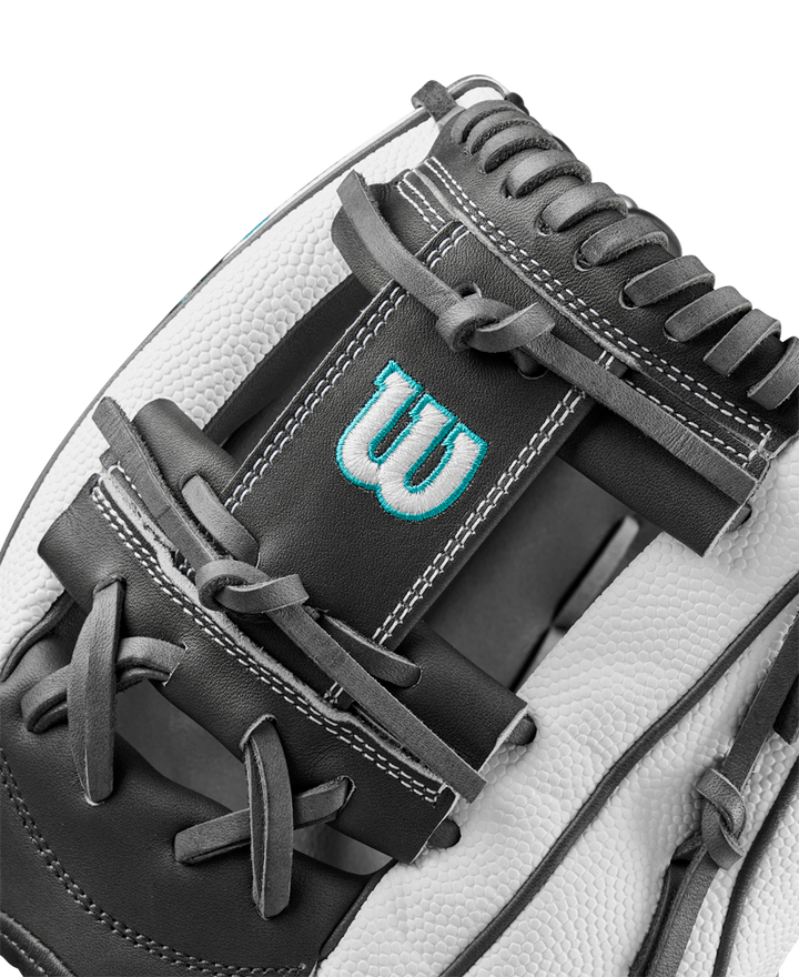 Close-up of the Wilson A2000 H75SS 11.75" Fastpitch Glove, showcasing black and white SuperSkin material, detailed stitching, laces, and a blue embroidered W logo on the leather.