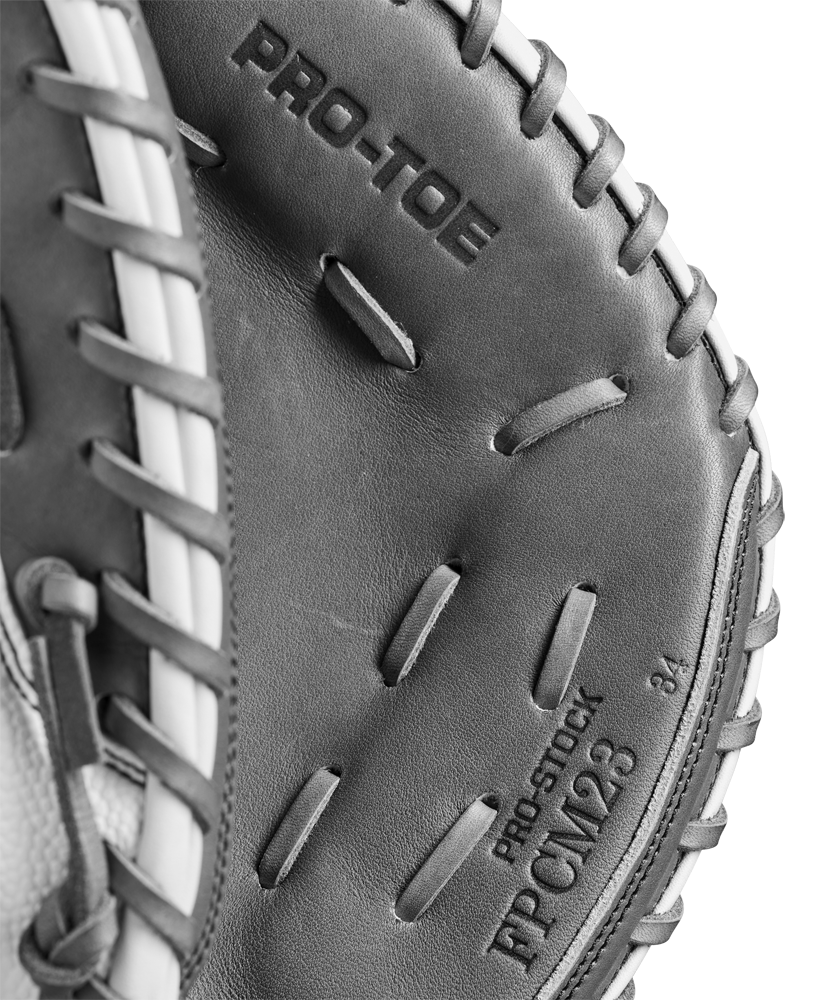 Close-up of a Wilson A2000 FPCM23 34" Fastpitch Catcher's Mitt (WBW10268134) in black and white, showing detailed stitching and "PRO-TOE" text, crafted from durable Pro Stock Leather by Wilson.