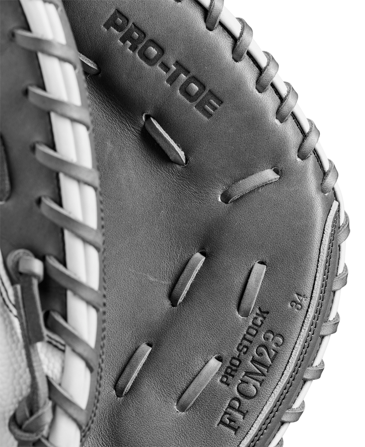 Close-up of a Wilson A2000 FPCM23 34" Fastpitch Catcher's Mitt (WBW10268134) in black and white, showing detailed stitching and "PRO-TOE" text, crafted from durable Pro Stock Leather by Wilson.