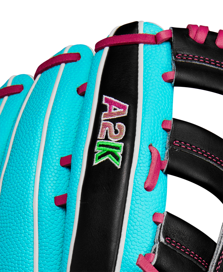 Close-up of the Wilson A2K 1810SS 12.75" Baseball Glove (Winter 2024) featuring turquoise Pro Stock Select leather, white piping, black accents, and pink stitching with an eye-catching pink, white, and green embroidered A2K logo.