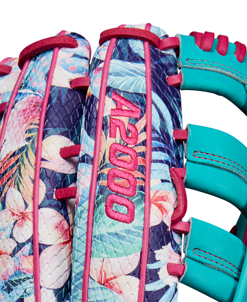 Close-up of the Wilson A2000 RA56 12.75" Randy Arozarena GM Baseball Glove, featuring a tropical floral pattern, teal blue lacing, SuperSnakeSkin accents, pink stitching, and bold pink A2000 embroidery. SPRING 2025 release.