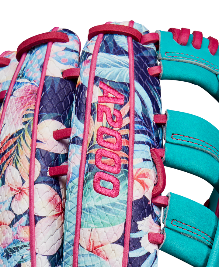 Close-up of the Wilson A2000 RA56 12.75" Randy Arozarena GM Baseball Glove, featuring a tropical floral pattern, teal blue lacing, SuperSnakeSkin accents, pink stitching, and bold pink A2000 embroidery. SPRING 2025 release.