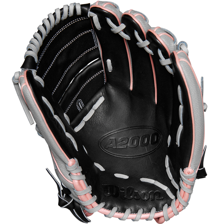 The Wilson A2000 MA14SS 12.25" Fastpitch Glove (WBW1027221225) features a black design with white and pink laces, crafted from Pro Stock leather and inspired by the Monica Abbott glove, shown open with visible palm and webbing.