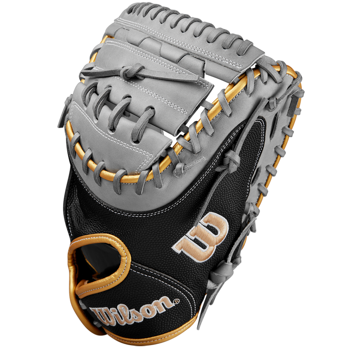 A close-up of the Wilson A2000 FPCM23 34" Fastpitch Catcher's Mitt with gray Pro Stock leather, tan laces, black SuperSkin accents, and gold and white embroidered W and Wilson logos. Brand: Wilson. Model: WBW10274434.
