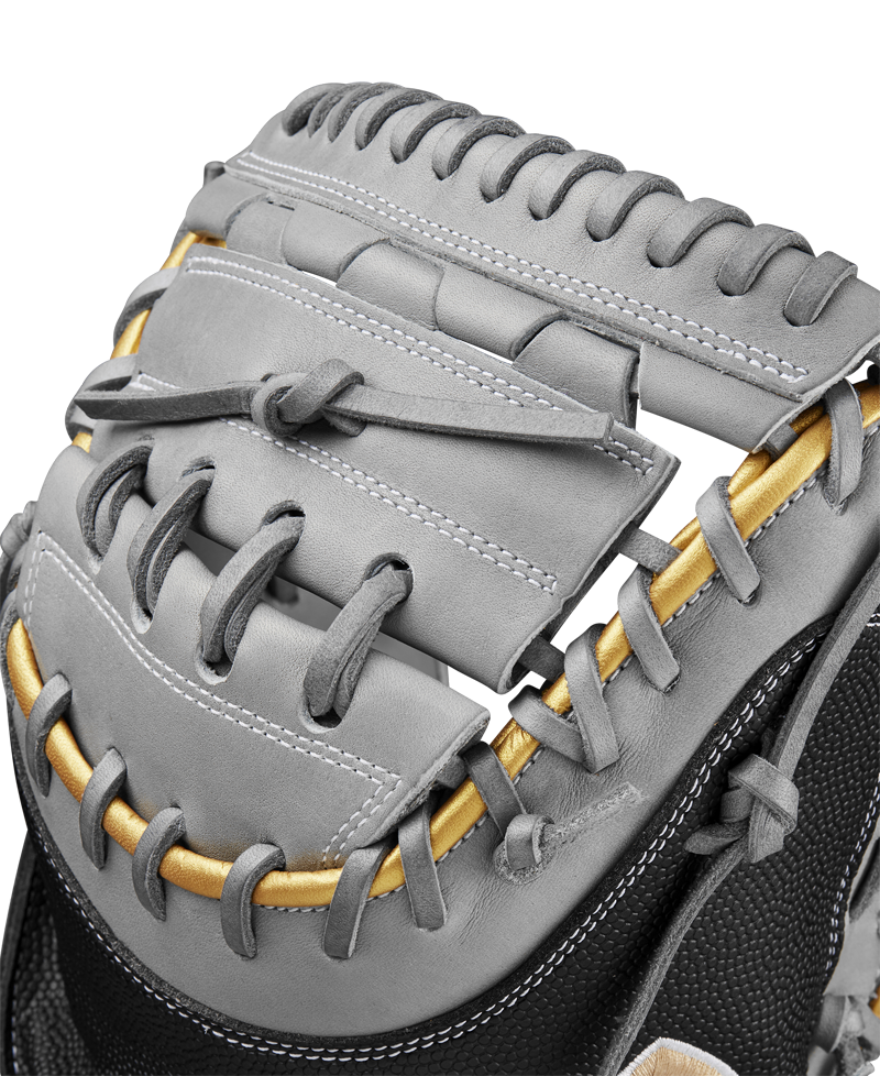 Close-up of a Wilson A2000 FPCM23 34" Fastpitch Catcher's Mitt in gray leather with gold and black accents, highlighting detailed stitching and lacing on the web—crafted for peak performance. Model: WBW10274434.