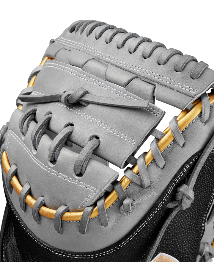 Close-up of a Wilson A2000 FPCM23 34" Fastpitch Catcher's Mitt in gray leather with gold and black accents, highlighting detailed stitching and lacing on the web—crafted for peak performance. Model: WBW10274434.