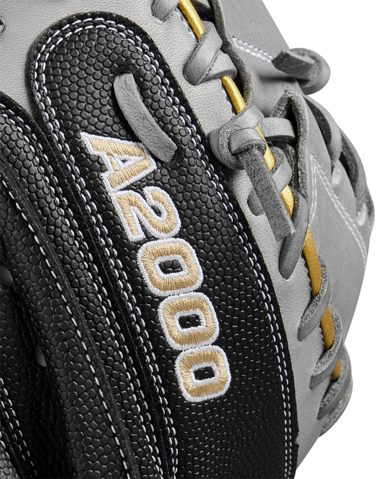 Close-up of the Wilson A2000 FPCM23 34" Fastpitch Catcher's Mitt in black and gray with yellow accents, made from Pro Stock leather and featuring white and gold "A2000" embroidery on the side.
