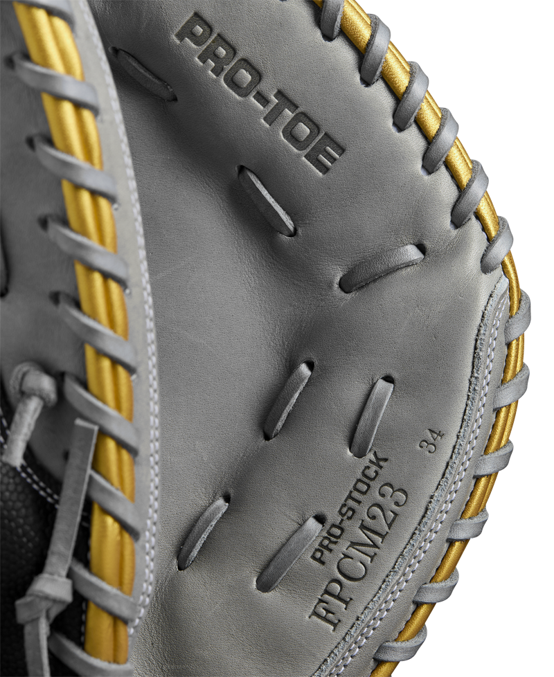 Close-up of the Wilson A2000 FPCM23 34" Fastpitch Catcher's Mitt (WBW10274434) by Wilson, featuring gray Pro Stock leather, gold lacing, and embossed "PRO-TOE," "PRO-STOCK," and "JPCML23" inside the pocket.