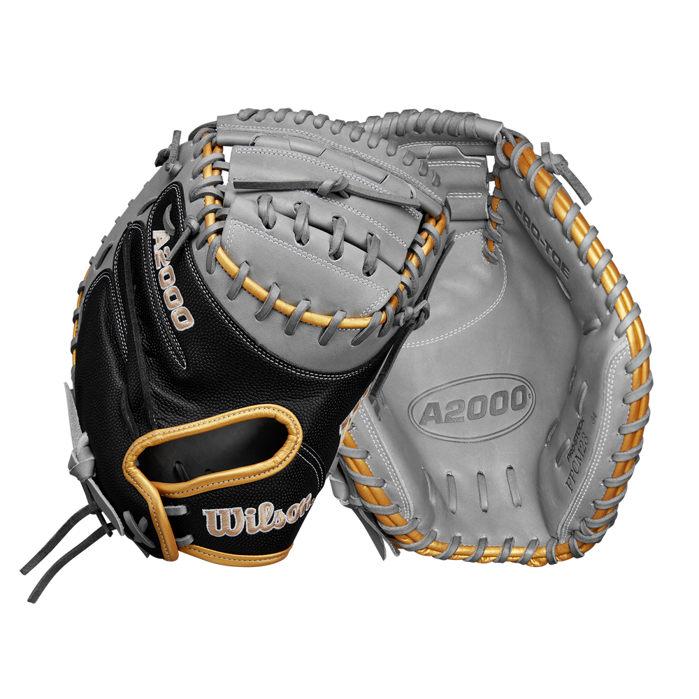 Two Wilson A2000 FPCM23 34" Fastpitch Catcher's Mitts are shown; one palm-up and one palm-down, highlighting the black, gray, and tan Pro Stock leather, webbing, detailed stitching, and the Wilson brand logo.