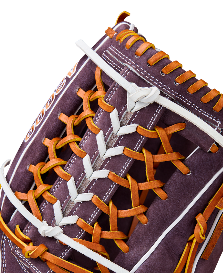 Close-up of the Wilson A2000 T125 12.5" Aliyah Andrews GM Fastpitch Glove (WBW102745125), showcasing dark brown leather with orange and white laces, detailed stitching, and craftsmanship inspired by Aliyah Andrews.