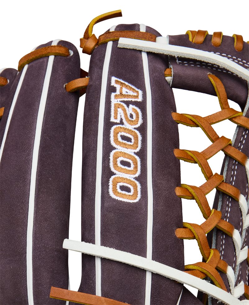 Close-up of a Wilson A2000 T125 12.5" Aliyah Andrews GM Fastpitch Glove (WBW102745125), a brown leather outfield glove with orange and white laces, featuring the embroidered A2000 logo, inspired by Aliyah Andrews.