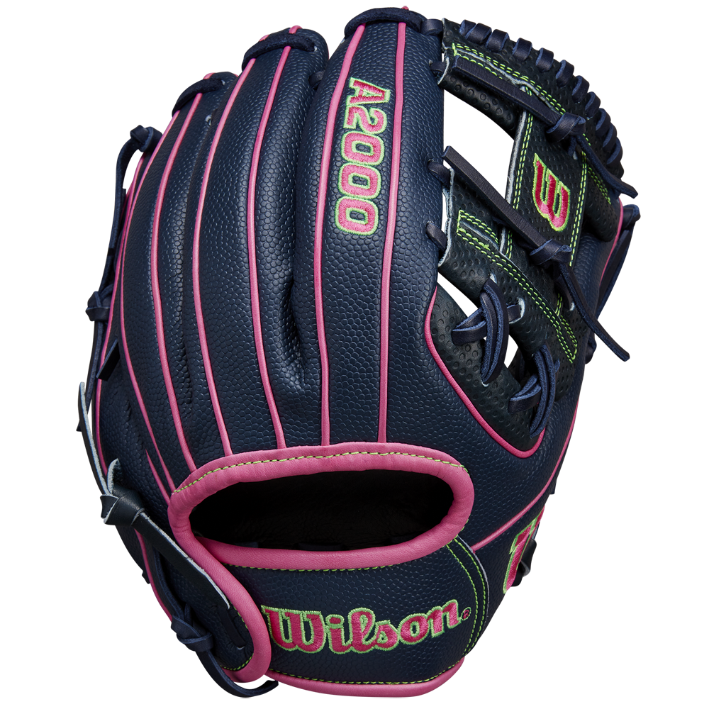 The Wilson A2000 DP15SS 11.5" Baseball Glove (SPRING 2025: WBW102747115) features a navy blue design with pink laces, neon green stitching, Pedroia Fit Technology, and Wilson branding on the wrist strap.