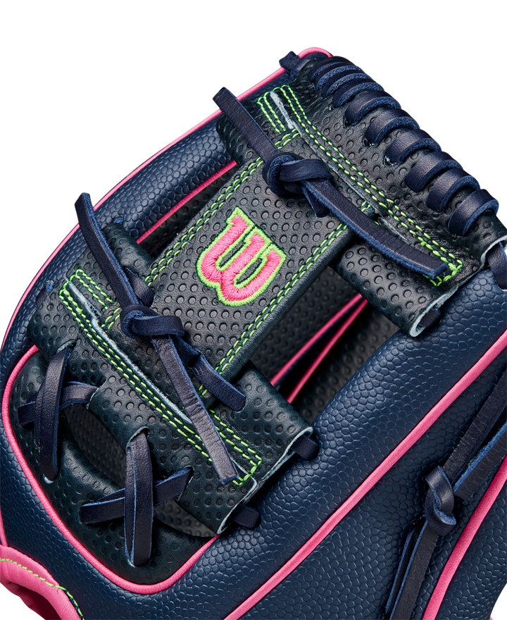 Close-up of the Wilson A2000 DP15SS 11.5" Baseball Glove (SPRING 2025), featuring navy blue leather, pink trim, neon green stitching, dark blue laces, Pedroia Fit Technology, a perforated texture, and a pink embroidered W logo.