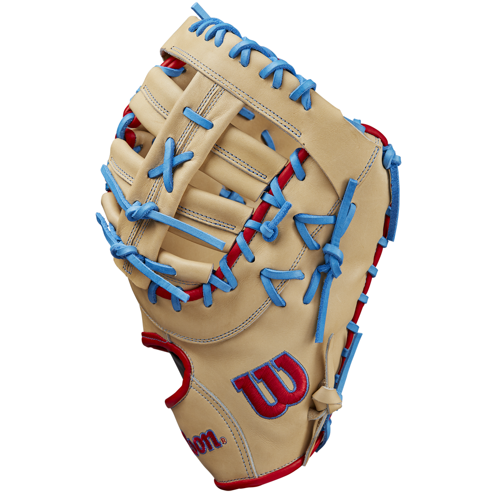 The Wilson A2000 1677 12.5" First Base Mitt (SPRING 2025: WBW102753125) by Wilson features tan Pro Stock leather, blue laces, red accents, and a red and blue logo on the thumb, displayed on a plain white background.