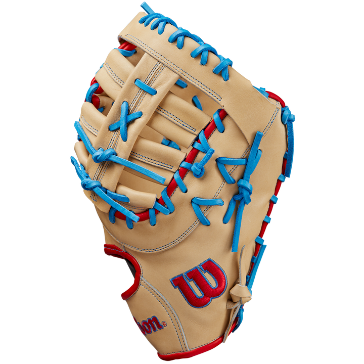The Wilson A2000 1677 12.5" First Base Mitt (SPRING 2025: WBW102753125) by Wilson features tan Pro Stock leather, blue laces, red accents, and a red and blue logo on the thumb, displayed on a plain white background.